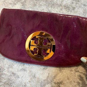 Tory Burch leather clutch in plum. Can be worn and styled with dresses, skirts o